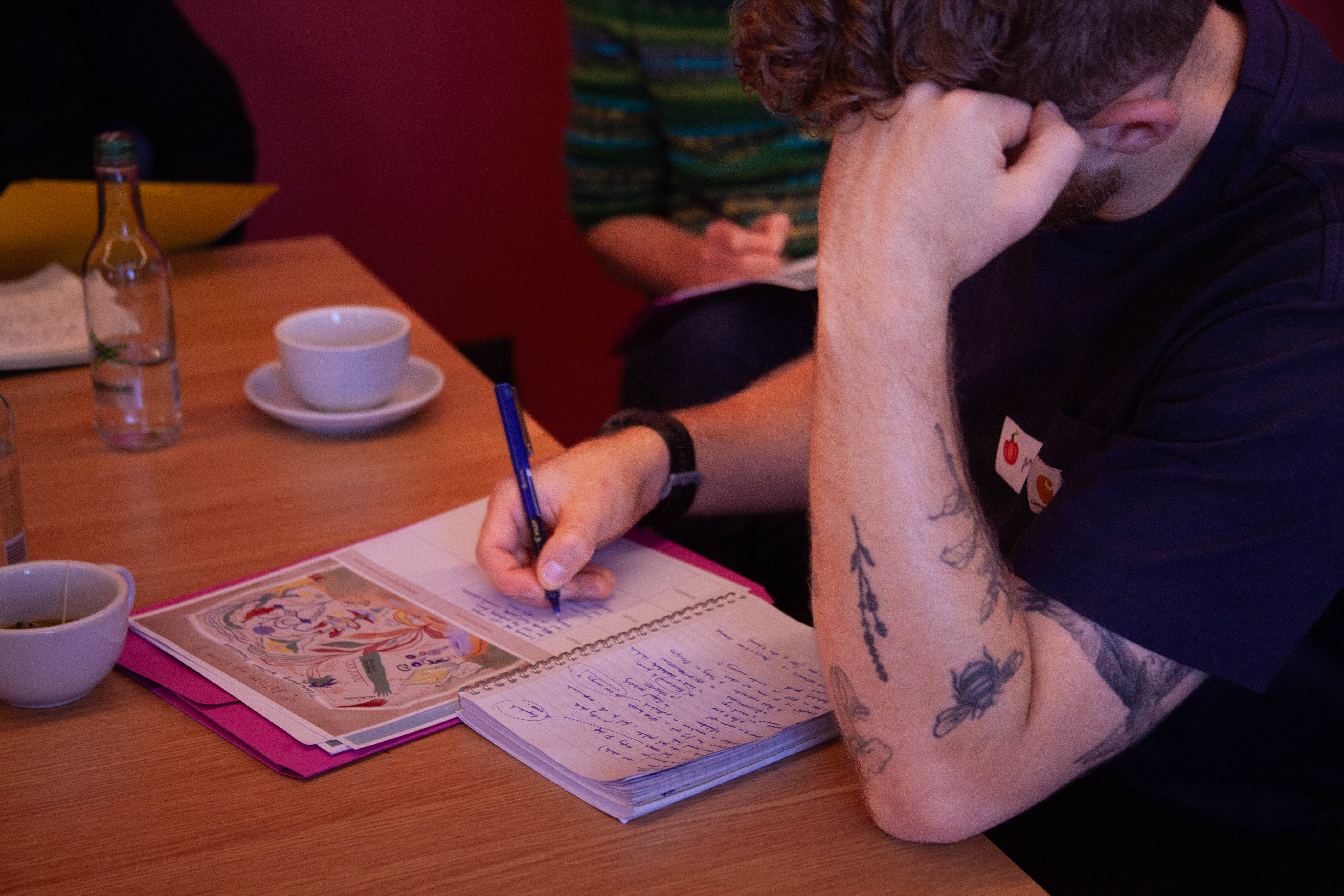 A workshop participant writes down reflections on a provided worksheet. Photo by Jacquelyn Turner.