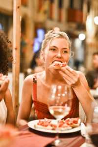 Image: Adrienn, Woman Eating Bruschetta, Pexels, Pexels Licence