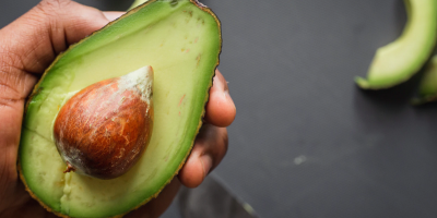 Image: Louis Hansel, person holding green and brown sliced fruit, Unsplash, Unsplash Licence