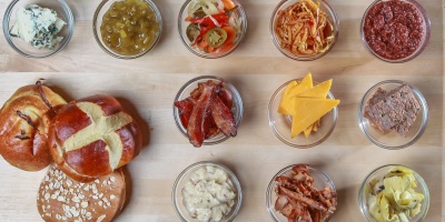 Charcuterie plate with mustards, cheeses, fruits, relishes, bacon, and breads. Tim Toomey via Unsplash.