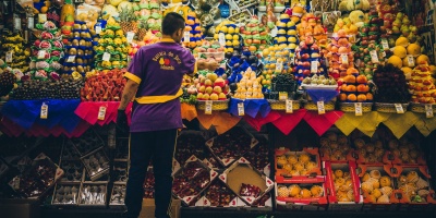 Photo of food market trader in São Paulo. Photo by D A V I D S O N L U N A via Unsplash