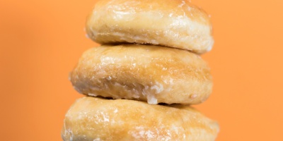 A pile of sugar coated doughnuts. Photo by Kyle Brinker via Unsplash.