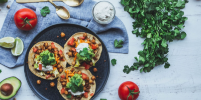 Image of three vegan tacos and other fresh ingredients. Photo by shanriley via Unsplash 
