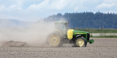 Image of a tractor ploughing a barren field. Photo by Chris LeBoutillier via Pixabay.