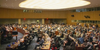 Photo of a full, large assembly room for negotiation. Image by mtenbruggencate via Unsplash.