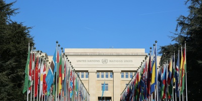 Image: UN building with member nation flags. Photo by Salya T via Unsplash