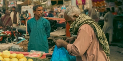 Man purchasing food at market. Photo by Qamar Rehman via Pexels