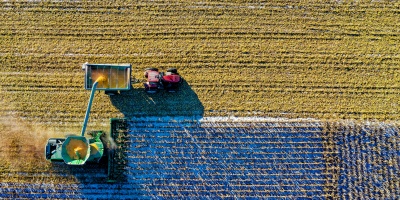 Bird's eye angle of combine harvester unloading into tractor and trailer. Credit: Tom Fisk