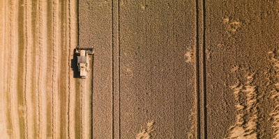 Aerial shot of field with combine harvester. Credit: Timon Reinhard via pexels