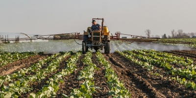 Photo of tractor with sprayer in field. Credit Stitch via Pexels