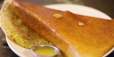 Image: Charles Haynes, Dosa (rice pancake) with a cup of ghee (clarified butter) at Mavalli Tiffin Room in Bangalore, Wikimedia Commons, Creative Commons Attribution-Share Alike 2.0 Generic