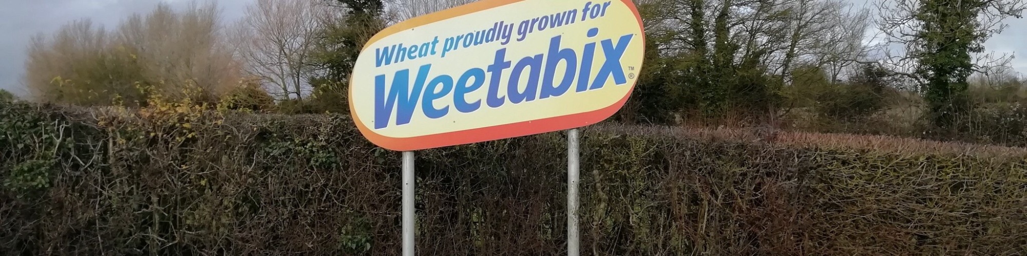 Photo by Mick Baker via Flickr. A sign of weetabix next to field