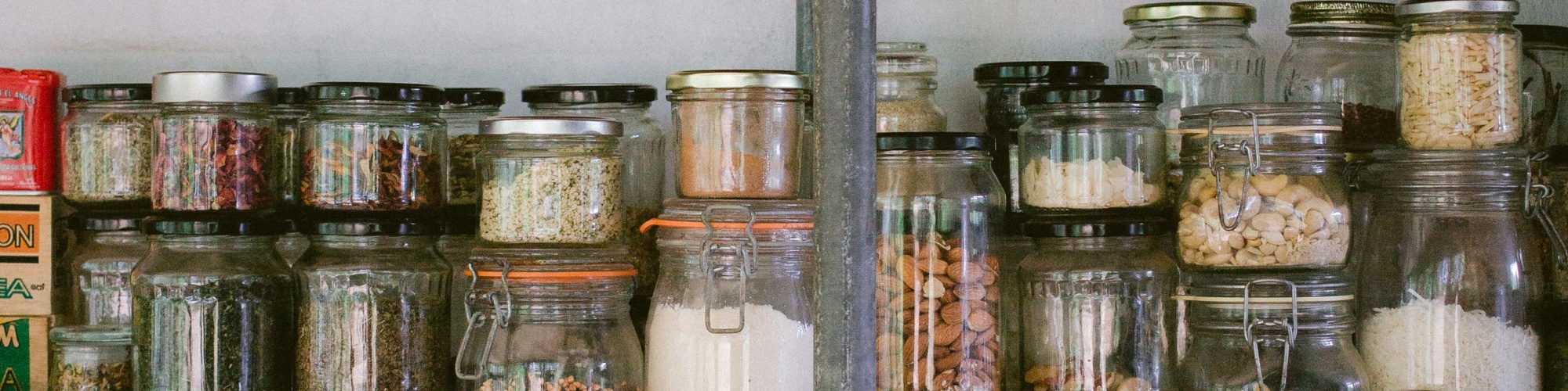 Jars of dry goods in a pantry. Photo by Luisa Brimble via Unsplash.