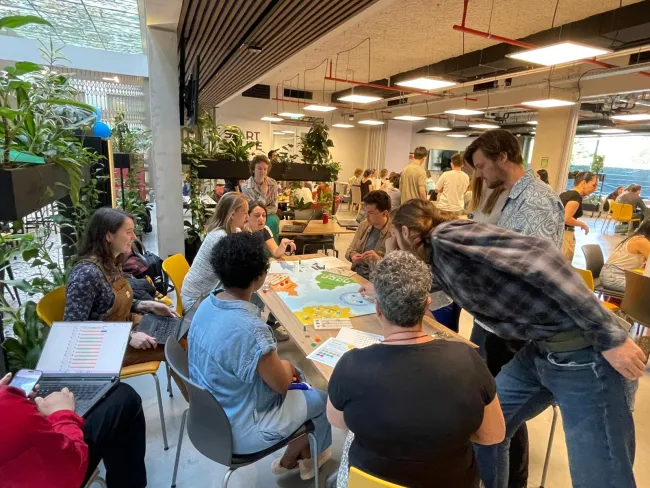 Provided by Frederico Andreotti for his Essay on Games on TABLE, pictures a group playing the student game 'Harvest Havoc', sent 30 April 2025