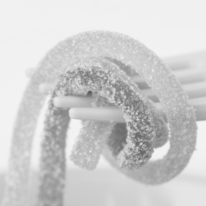 A fork with sugary looking sweets on it.