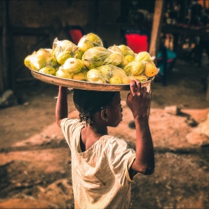 A street hawker selling food in Nassarawa, Nigeria. Photo by victor olamide ajibola via Unsplash