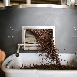 Photo of Coffee Beans being processed by a machine. Photo by Andrew Neel via Unsplash