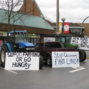 Image: Tractors with protest signs in the street. Photo by stopthepave via flickr