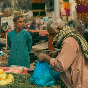 Man purchasing food at market. Photo by Qamar Rehman via Pexels